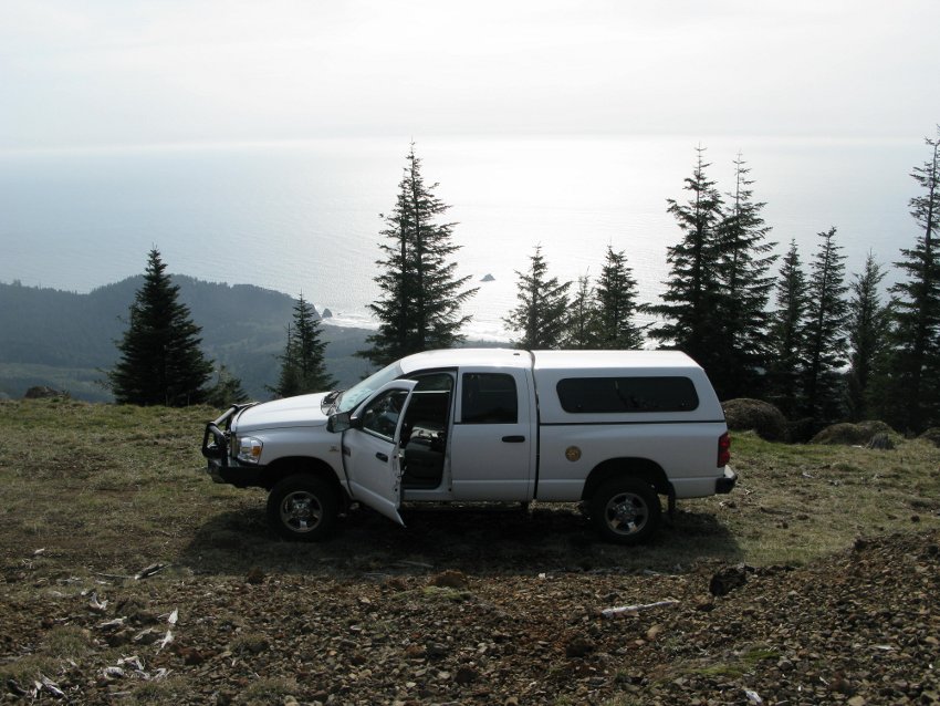 Truck with ocean in background.