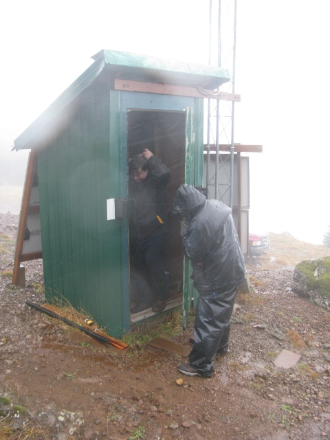 Tim holds the door against the wind